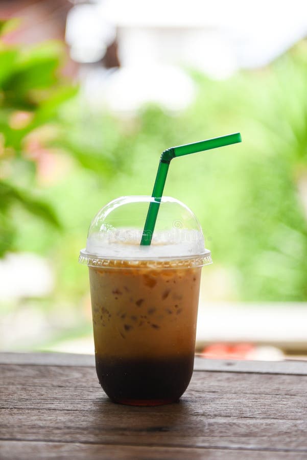 https://thumbs.dreamstime.com/b/iced-coffee-latte-plastic-cup-wooden-table-nature-green-background-drinks-194360176.jpg