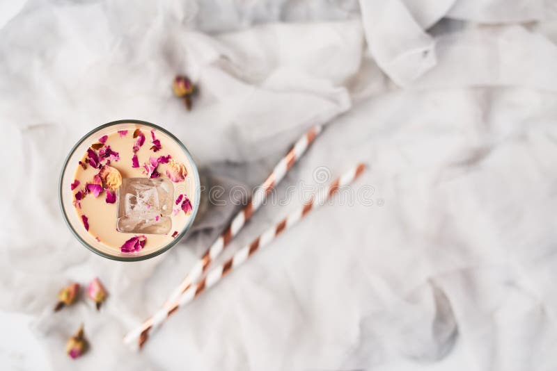 Iced coffee with rose and cardamom in a tall glass stock photography Iced coffee with rose and cardamom in a tall glass stock photography
