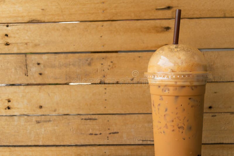 Coffee, Iced Coffee Mocha and Blur Menu Book on Table Wood Backg Stock