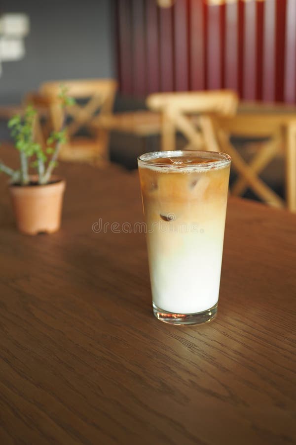 Iced late in a transparent glass on cafe table royalty free stock photos