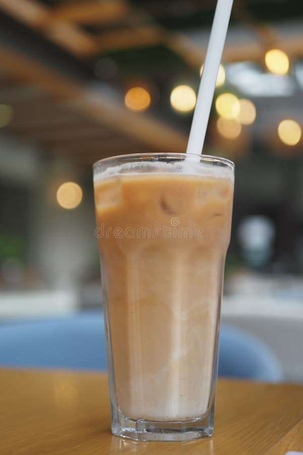 Iced late in a transparent glass on cafe table royalty free stock photo