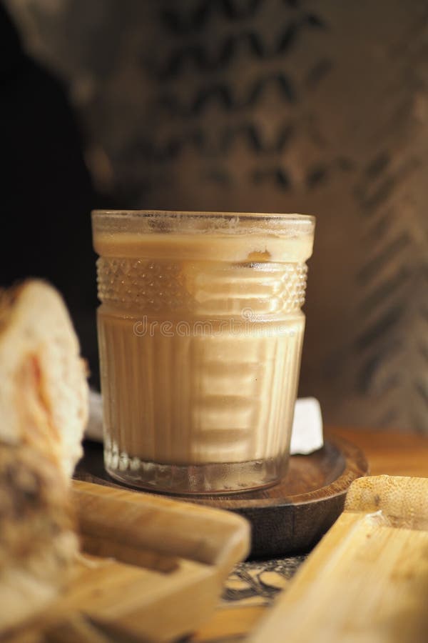Iced late on wooden table in coffee shop royalty free stock image