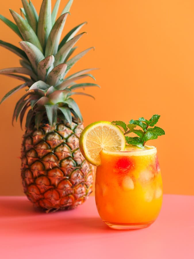 Iced Pineapple Punch Cocktail in Glass on Orange Background. Summer Drink Stock Photo - Image of ...