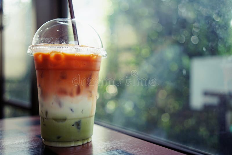 https://thumbs.dreamstime.com/b/iced-three-layers-beverage-consist-thai-tea-milk-green-tea-plastic-cup-blurry-bokeh-background-copy-space-114555479.jpg