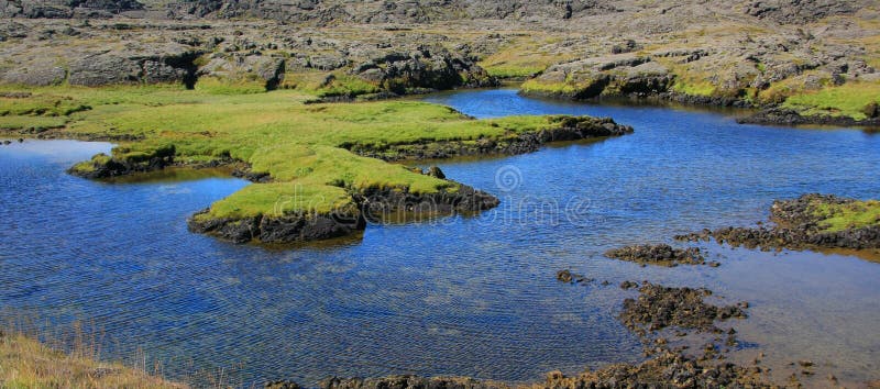Unique Icelandic inlet with crystal clear water and moss covered lava rock. Unique Icelandic inlet with crystal clear water and moss covered lava rock.