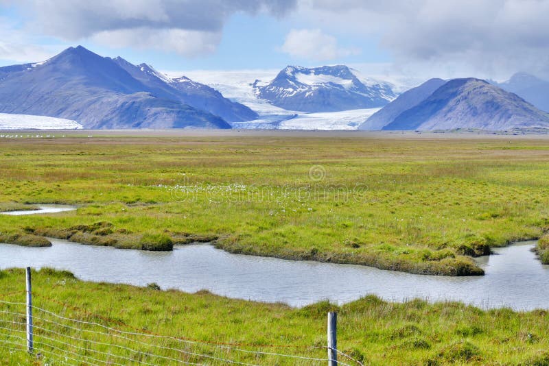 Icelandic grass and moss landscape with glacier / volcano in the background stock photos