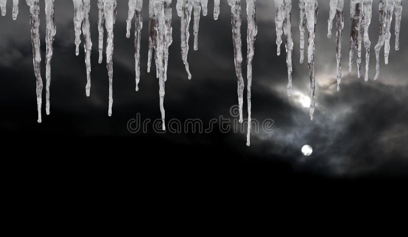 Icicles on dark winter sky