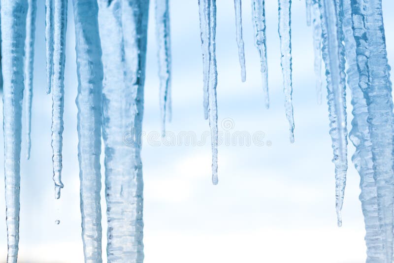 Icicles hanging down with blue sky