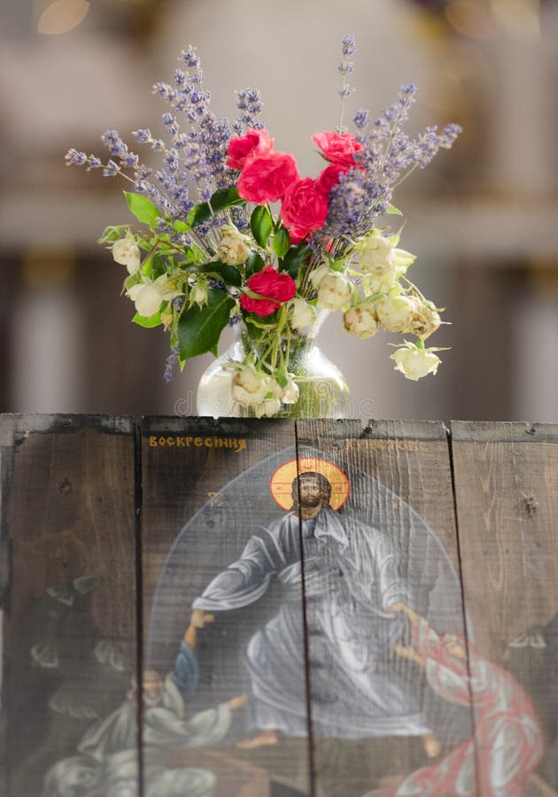 Resurrection of Christ Icon and a beautiful bouquet of flowers in a vase in a church