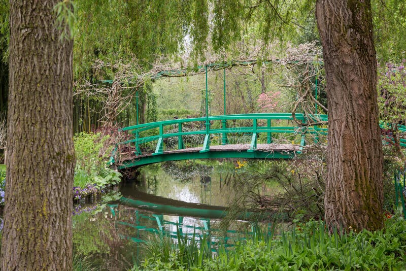The iconic green Japanese bridge in Monet`s garden at Giverny in