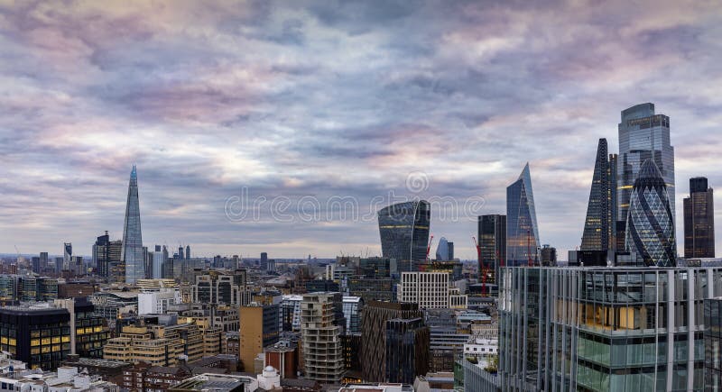 The iconic skyline of London, United Kingdom, from the City to London Bridge during a colorful, cloudy evening