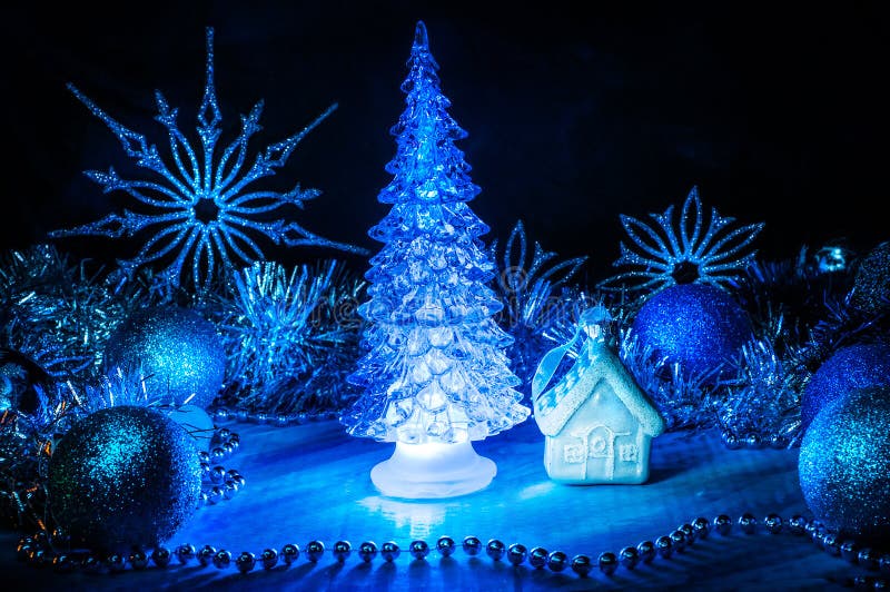 Icy Christmas Tree Glowing with Blue Light on a Blue Background Stock ...