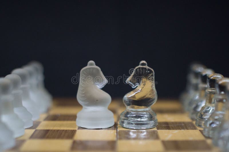 Icy Knight chess pieces on a black background royalty free stock photography