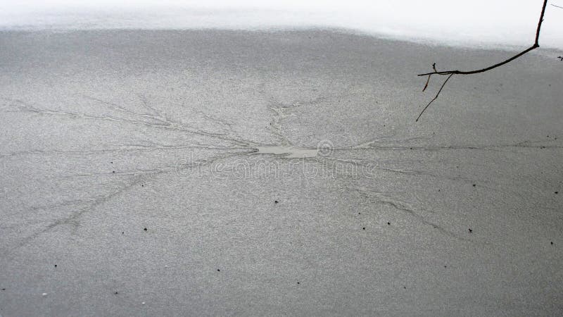 Cracked frozen lake snowflake stock photo