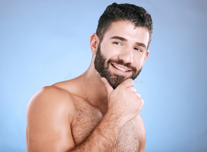 Idea, beauty and natural with a man model in studio on a blue background for skincare, wellness or grooming. Face, beard