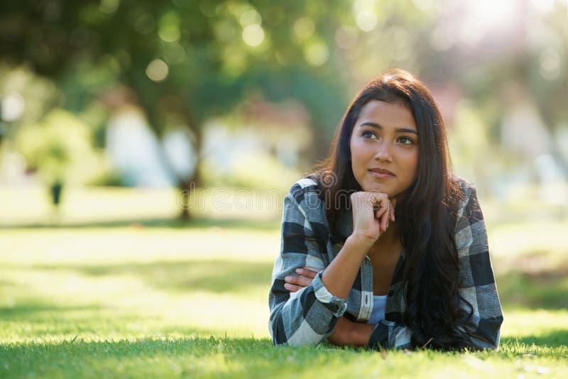 Ideas, nature or woman thinking on grass to relax for rest in garden, park or field with peace. Daydream, vision or