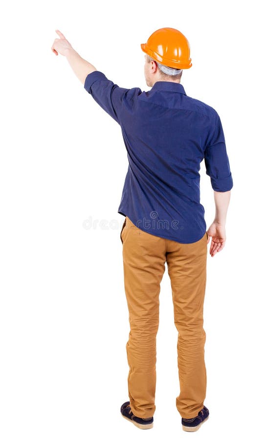 Ideia traseira de apontar homens novos na camisa e no capacete imagem de stock royalty free Ideia traseira de apontar homens novos na camisa e no capacete imagem de stock royalty free