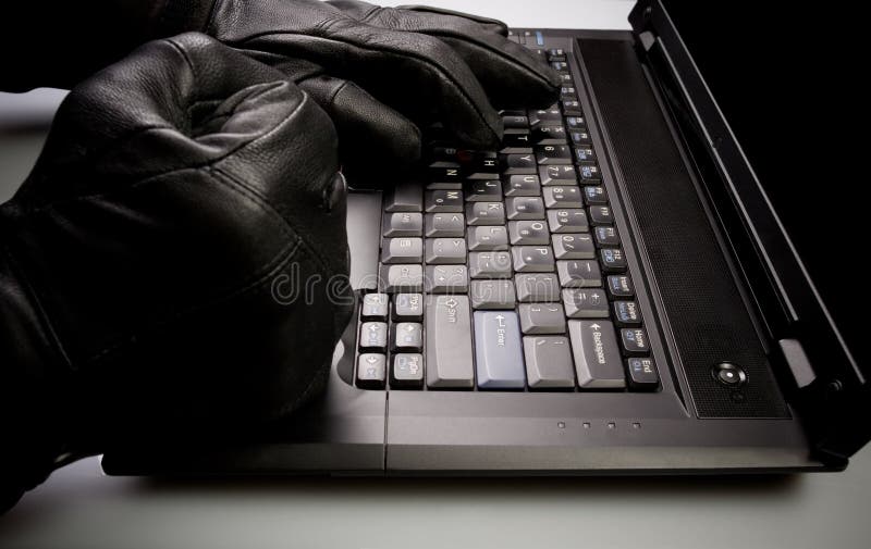 Identity theft, hacker working on laptop royalty free stock photography