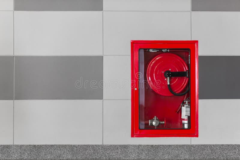 Hydrant with water hoses and fire extinguish equipment on the wall in an corridor. Hydrant with water hoses and fire extinguish equipment on the wall in an corridor.