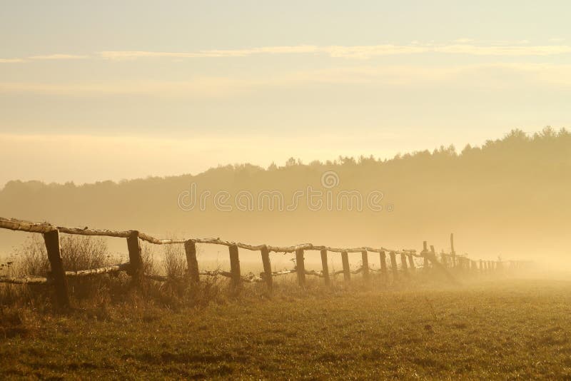 Idyllic fence on a misty field at sunrise royalty free stock image Idyllic fence on a misty field at sunrise royalty free stock image