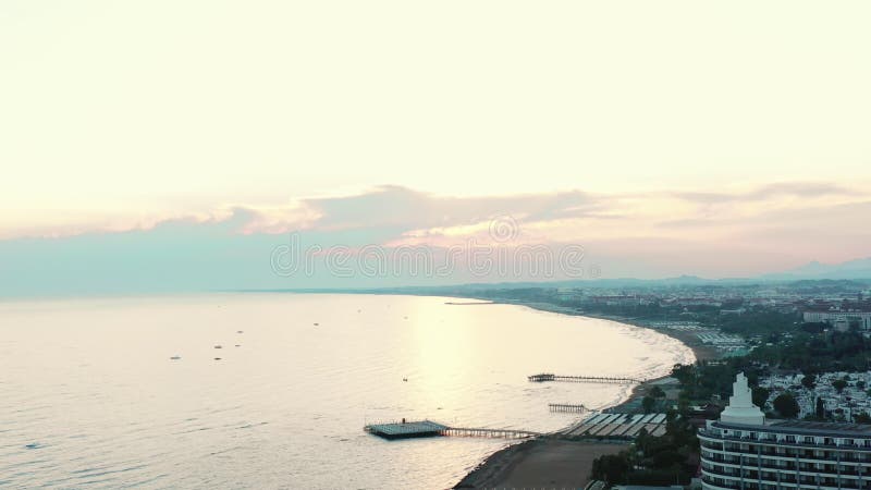 IDYLLIC NATURE BACKGROUNDS Amazing aerial view of sunset sky over Side, Turkey, sea coast with hotels on sandy beach.