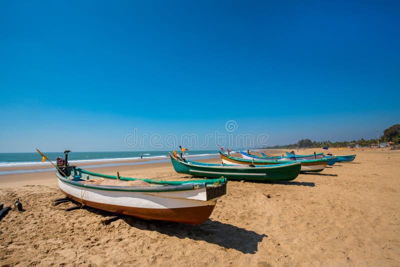 Idyllic scene at South Asia India : fishing boats on the sand and beach of Indian Ocean. Close to these place houses of fishers royalty free stock image Idyllic scene at South Asia India : fishing boats on the sand and beach of Indian Ocean. Close to these place houses of fishers royalty free stock image