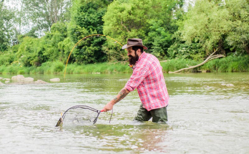 If Fish Regularly You Know How Rewarding And Soothing Fishing Is. Fishing Hobby. Bearded Brutal Fisher Catching Trout