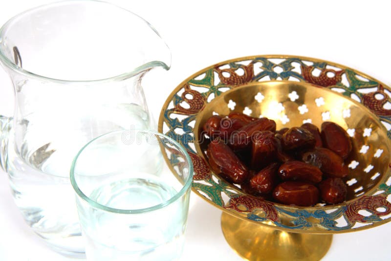 A bowl of dates and a jug and glass of water - the things used to break the fast at sunset during the Muslim holy month of Ramadan. A bowl of dates and a jug and glass of water - the things used to break the fast at sunset during the Muslim holy month of Ramadan
