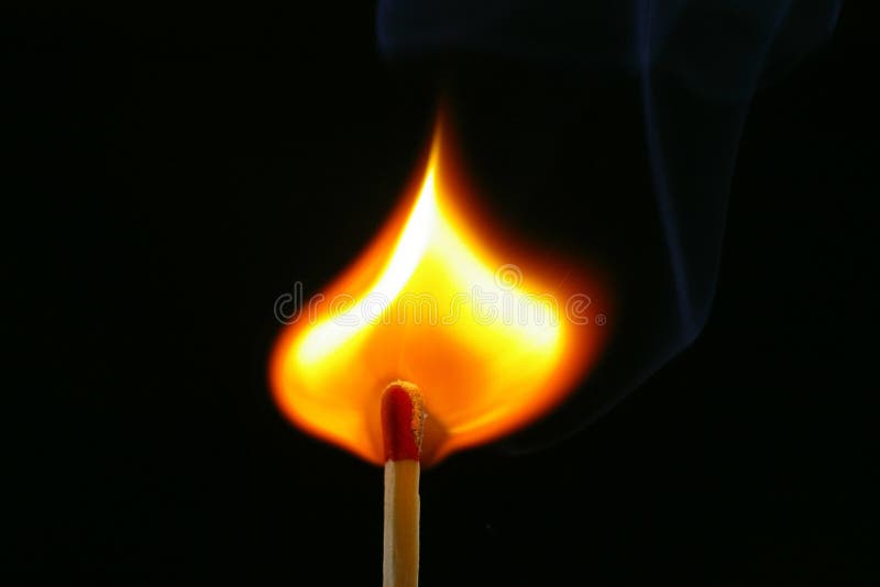 Closeup of a red-tipped wooden match stick at ignition. Red, orange, yellow, and white flame. Black background. Closeup of a red-tipped wooden match stick at ignition. Red, orange, yellow, and white flame. Black background.