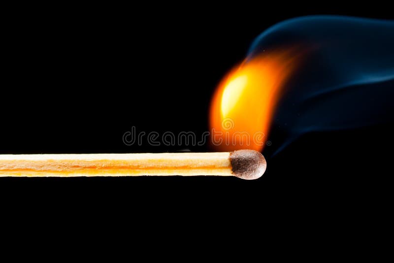 Igniting match with smoke, black background