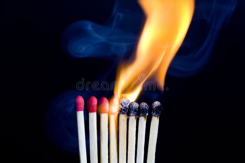 Igniting Matches from a Candle Fire. Sulfur Ignition Close Up Stock