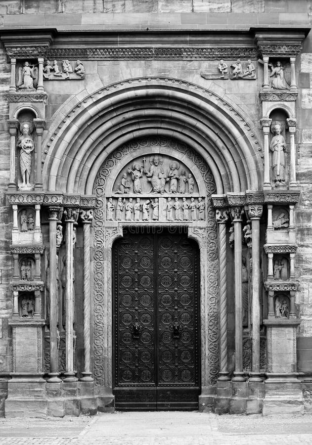 A black and white view of an elaborate and highly decorated doorway to the 12th Century Gothic Cathedral at Basel, Switzerland. A black and white view of an elaborate and highly decorated doorway to the 12th Century Gothic Cathedral at Basel, Switzerland.