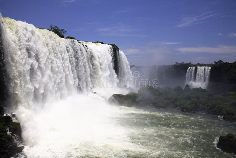 Iguassu (Iguazu; Iguaçu) Falls - Large Waterfalls. The Iguassu (or Iguazu) Falls is one of the largest masses of fresh water on the planet and divides, in South royalty free stock photos Iguassu (Iguazu; Iguaçu) Falls - Large Waterfalls. The Iguassu (or Iguazu) Falls is one of the largest masses of fresh water on the planet and divides, in South royalty free stock photos