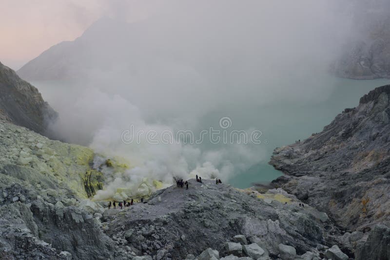 Ijen Crater, Indonesia. Ijen Crater has a 1km-wide turquoise colored acid crater lake, the largest highly acidic crater lake in the world. The pH of the water in stock photography Ijen Crater, Indonesia. Ijen Crater has a 1km-wide turquoise colored acid crater lake, the largest highly acidic crater lake in the world. The pH of the water in stock photography