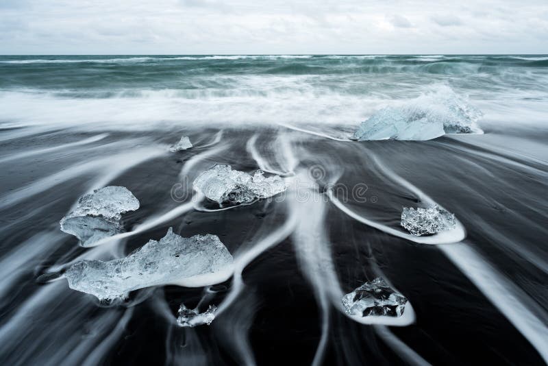 Ijs op het strand met zwart zand in IJsland stock afbeelding Ijs op het strand met zwart zand in IJsland stock afbeelding