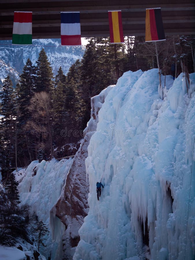 Alpinist ascenting a frozen waterfall in Ice park, Ouray. Alpinist ascenting a frozen waterfall in Ice park, Ouray.