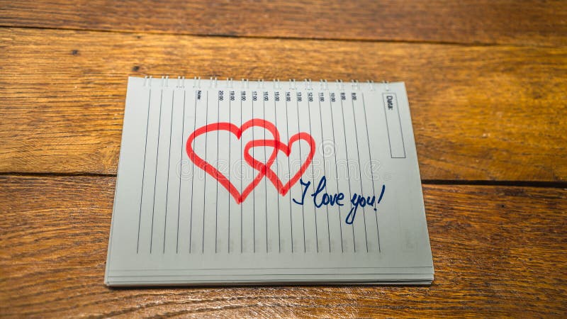 I love you, writing love text on paper, lovely message. Text on spiral agenda. Romantic, love concept. Valentine`s day. I love you, writing love text on paper, lovely message. Text on spiral agenda. Romantic, love concept. Valentine`s day