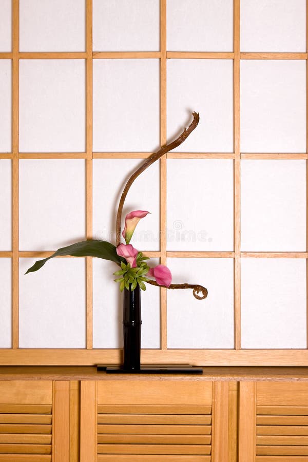 Ikebana flower arrangement in a japanese interior against an authentic shoji sliding window. Ikebana flower arrangement in a japanese interior against an authentic shoji sliding window