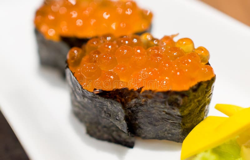 ClosedUp Ikura Salmon Roe Sushi Wraped with Salmon. Stock Photo
