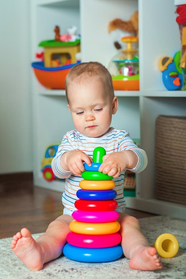 Il bambino riproduce un costruttore domestico colorato e lo spazio di copia. sviluppo di bambini dalla nascita immagini stock libere da diritti
