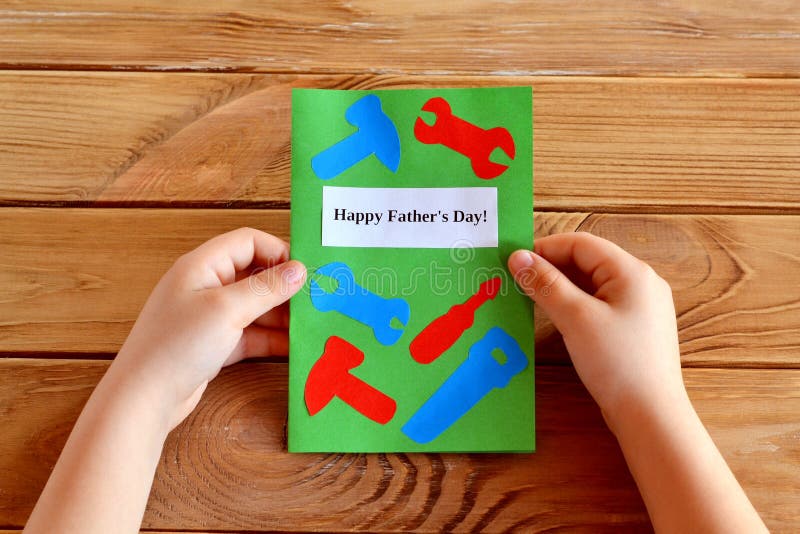 Homemade fathers day greeting card idea. Preschool and kindergarten paper crafts. Handmade card idea. Happy father&#x27;s day. Wooden table. Father&#x27;s day greeting card from a child. Surprise gift for father from son. Fathers day card gift with tools. Father&#x27;s day card with dad objects. Father&#x27;s day celebration card with tools flat lay. Father day card present with tools. Father&#x27;s day offer top view. Happy Fathers day special gifts with tools for dad. Homemade fathers day greeting card idea. Preschool and kindergarten paper crafts. Handmade card idea. Happy father&#x27;s day. Wooden table. Father&#x27;s day greeting card from a child. Surprise gift for father from son. Fathers day card gift with tools. Father&#x27;s day card with dad objects. Father&#x27;s day celebration card with tools flat lay. Father day card present with tools. Father&#x27;s day offer top view. Happy Fathers day special gifts with tools for dad
