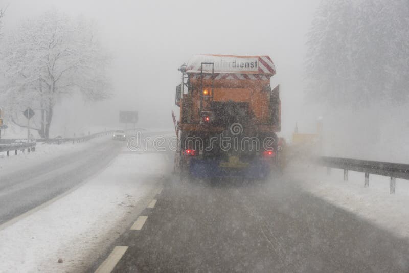 Truck removes snow from road in germany at very bad winter weather. Truck removes snow from road in germany at very bad winter weather