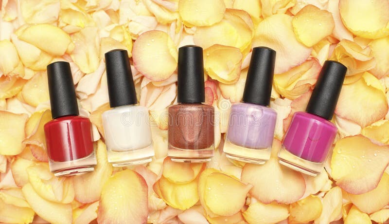 Nail polish in rose petals - beauty background. Nail polish in rose petals - beauty background