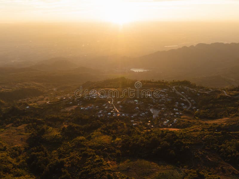 The golden sunset sky bathes a secluded mountain village. The golden sunset sky bathes a secluded mountain village