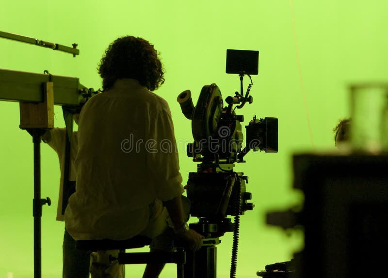 Il cineoperatore sopra greenscreen fotografia stock Il cineoperatore sopra greenscreen fotografia stock