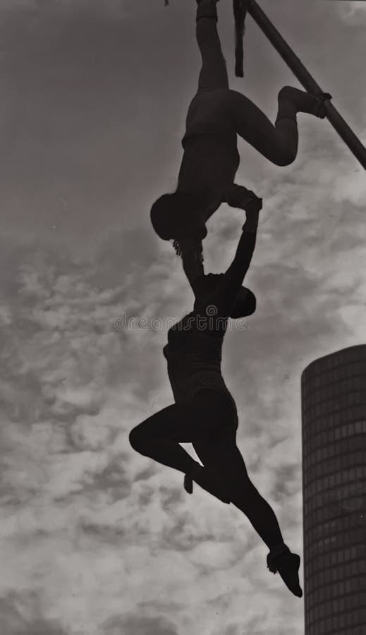 A monochrome silhouette captures circus daredevils performing a risky routine at the Navy Pier during ChicagoFest in August, 1978. A monochrome silhouette captures circus daredevils performing a risky routine at the Navy Pier during ChicagoFest in August, 1978.