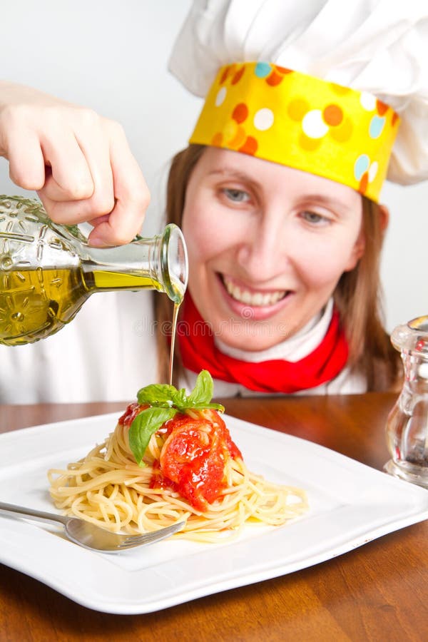 Il cuoco unico sorridente guarnisce un piatto italiano della pasta