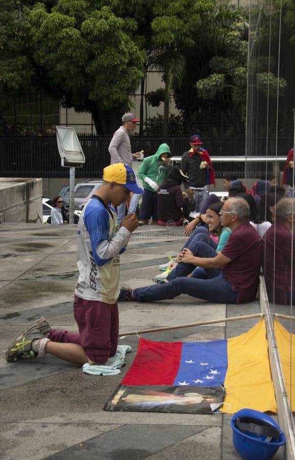 Il dimostrante dice che un pregare prima della partecipazione nel caso ha chiamato la madre di tutte le proteste nel Venezuela co fotografia stock Il dimostrante dice che un pregare prima della partecipazione nel caso ha chiamato la madre di tutte le proteste nel Venezuela co fotografia stock