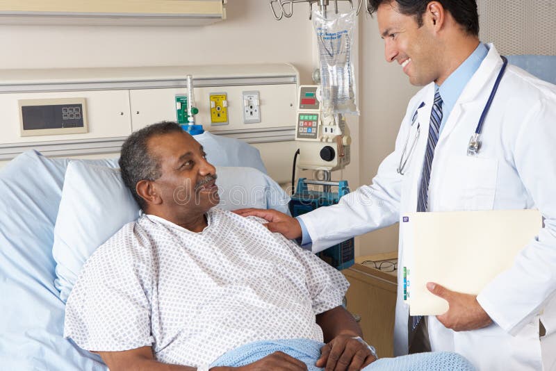 Male Doctor Visiting Senior Male Patient On Ward. Male Doctor Visiting Senior Male Patient On Ward