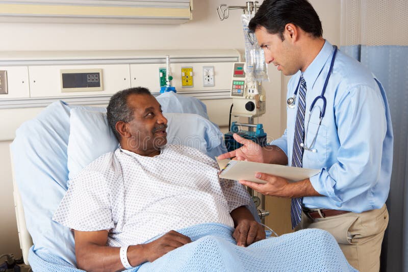 Male Doctor Visiting Senior Male Patient On Ward. Male Doctor Visiting Senior Male Patient On Ward